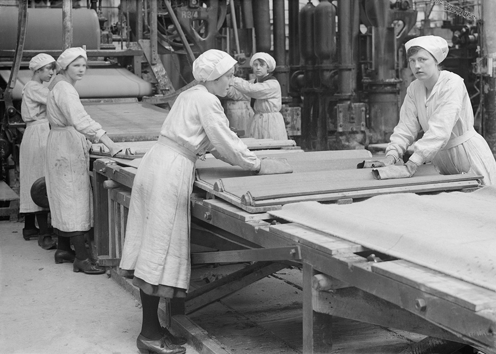 Factory workers with asbestos sheets